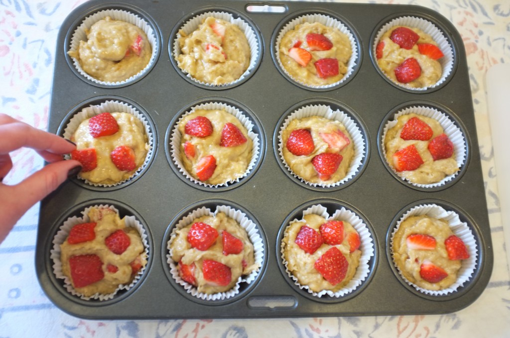 Les petits morceaux de fraises déposés sur le dessus de la pâte décorent les muffins