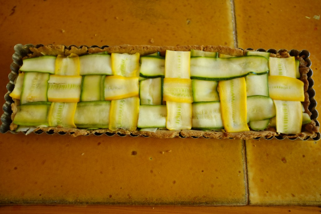 La tarte sans gluten courgette et poireau est tressée en alternace de courgettes jaunes et vertes